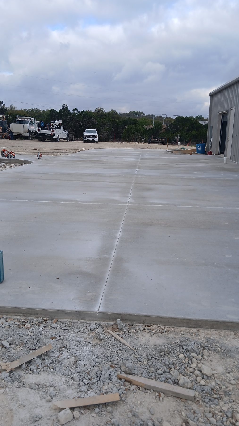 Large slab poured beside a metal building