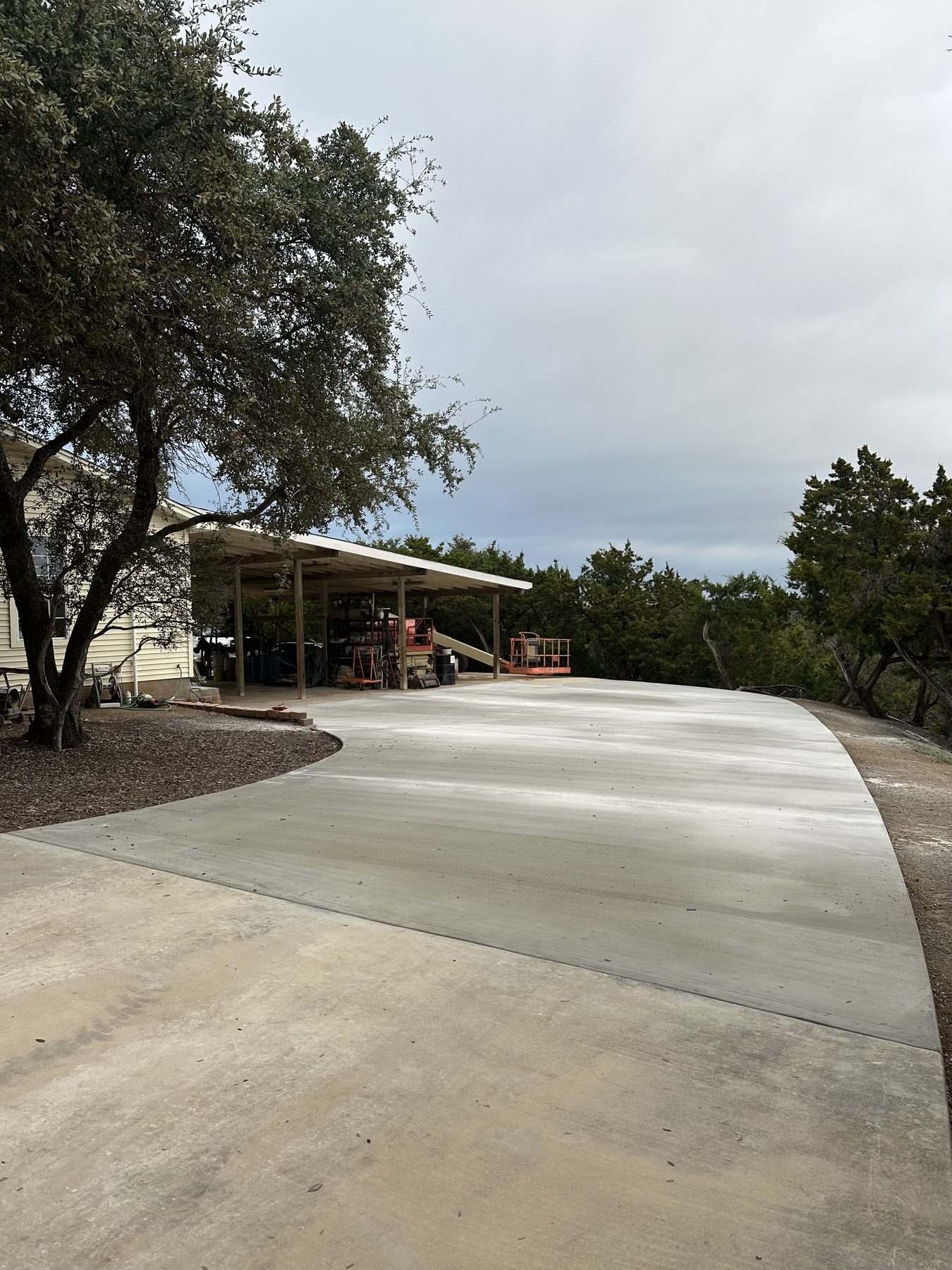 New driveway sweeping to a carport