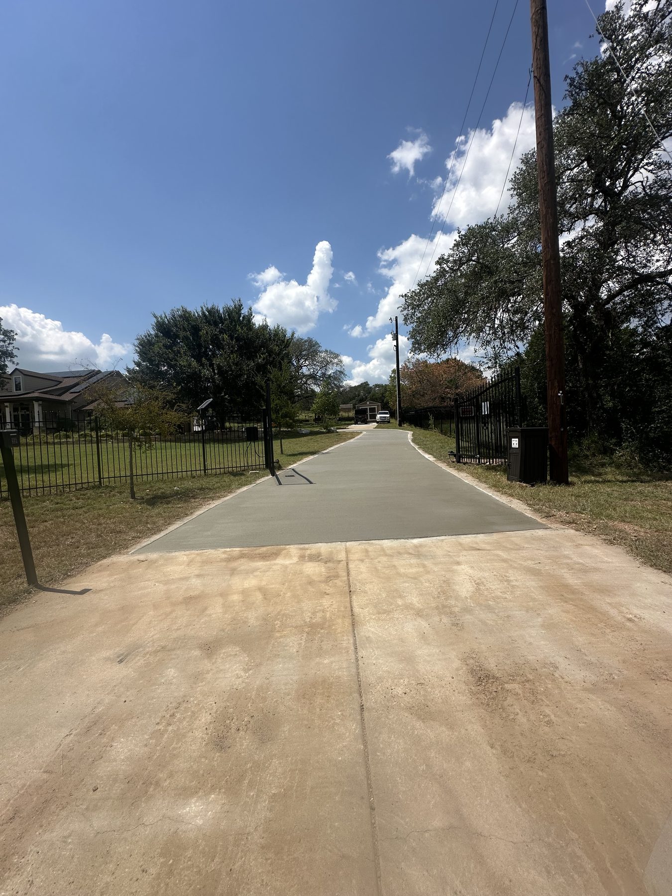 Long straight driveway pour on a rural lot