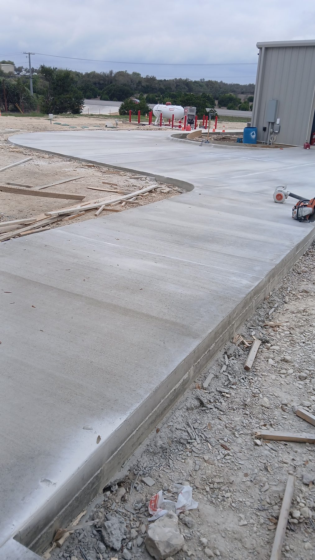 New concrete approach and pad at a metal shop building
