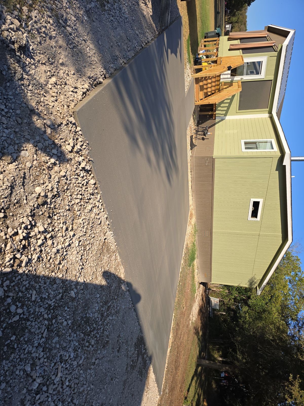 Sloped driveway poured beside a two-story house