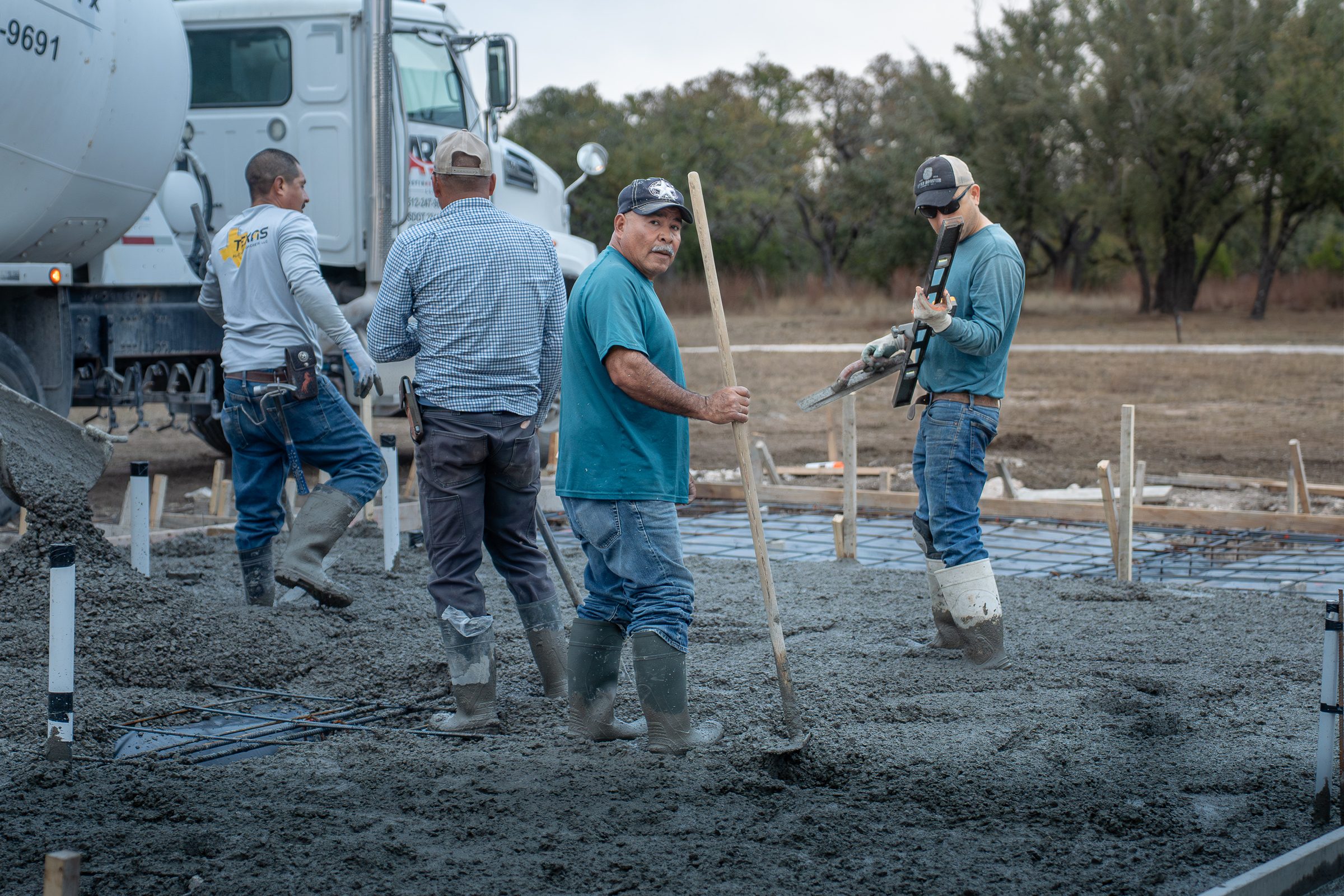 Crew meeting the mixer truck as the pour begins