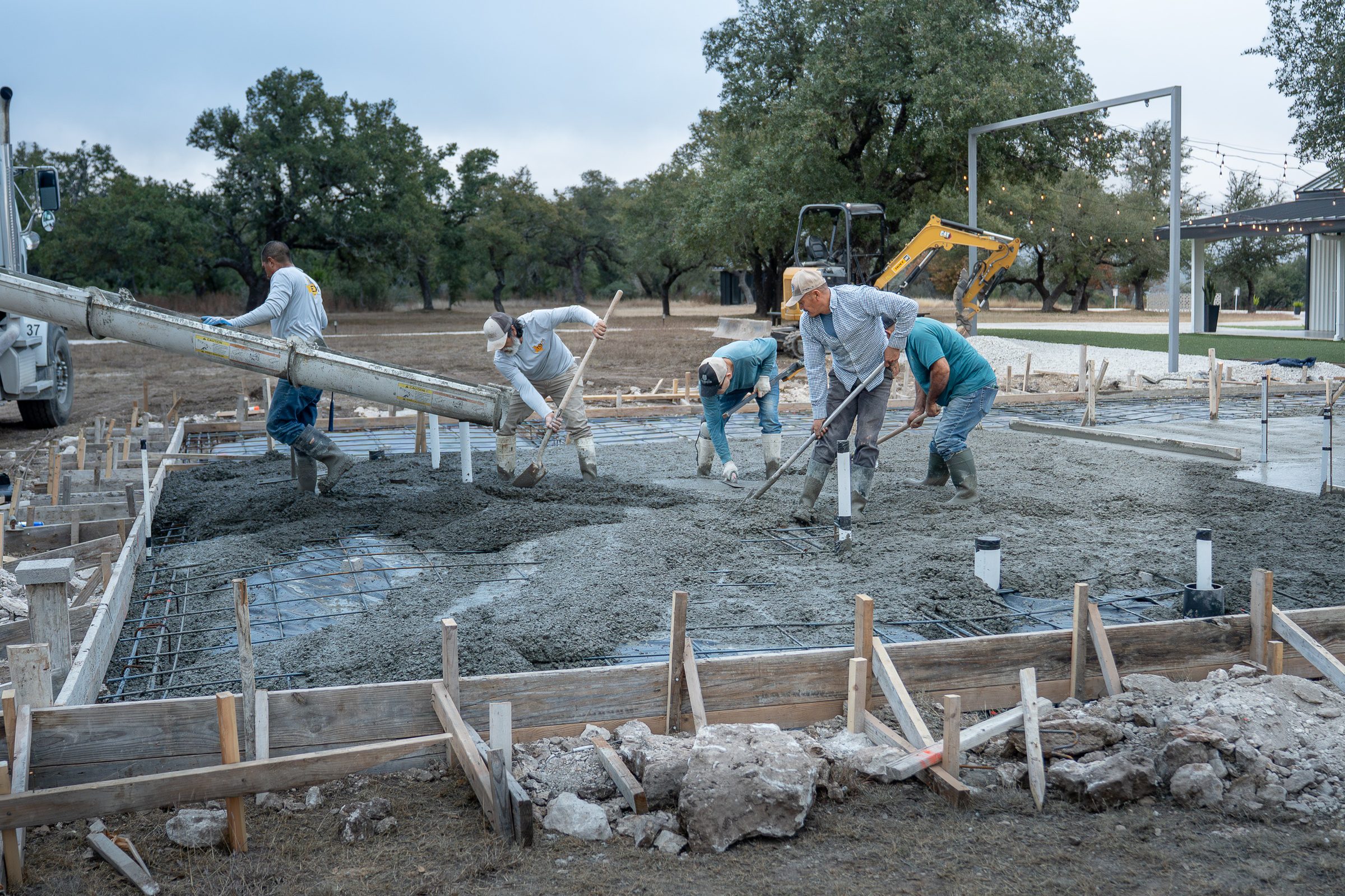 Placing concrete from the truck across a formed pad