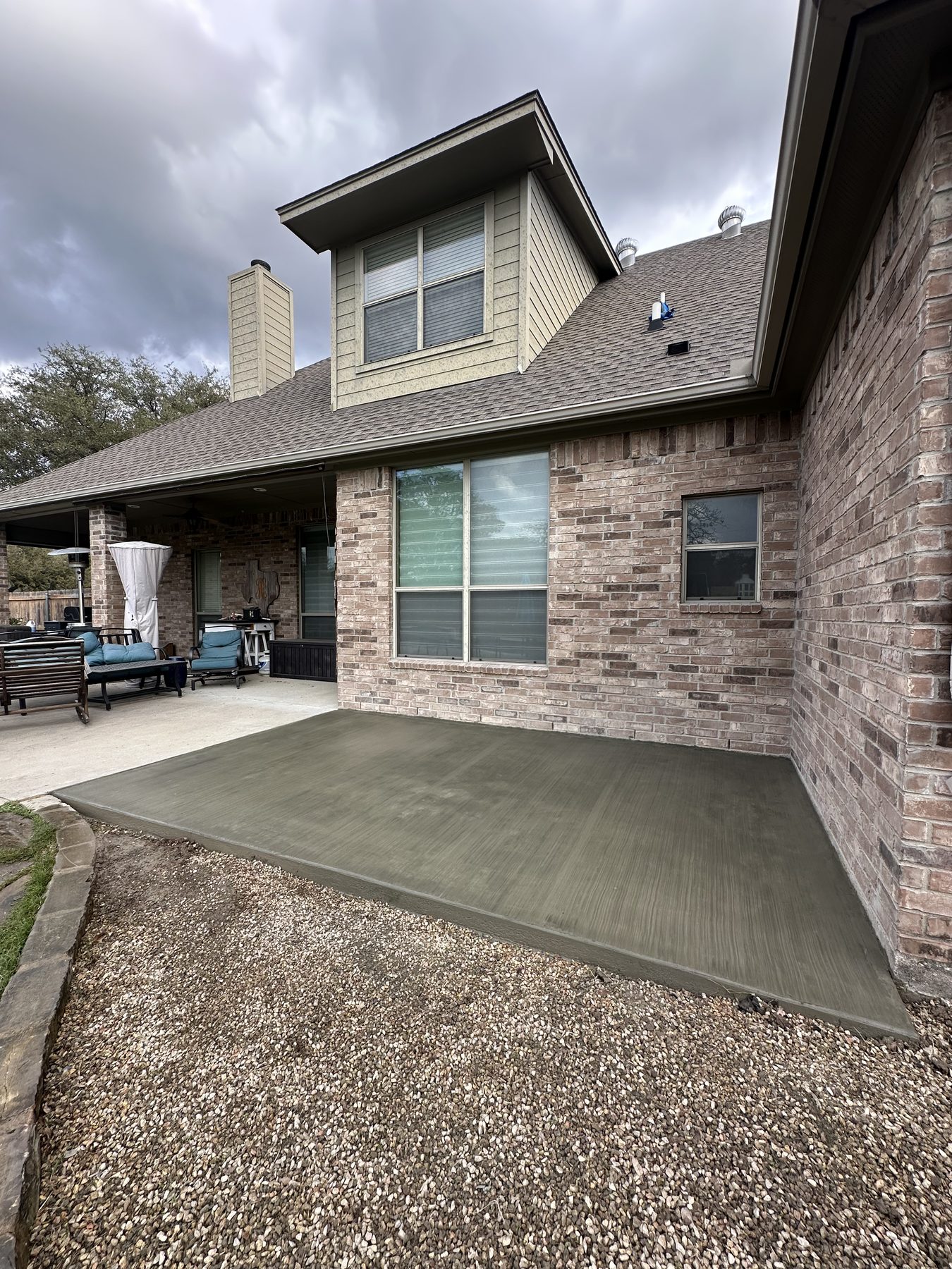 Back patio poured behind a brick home