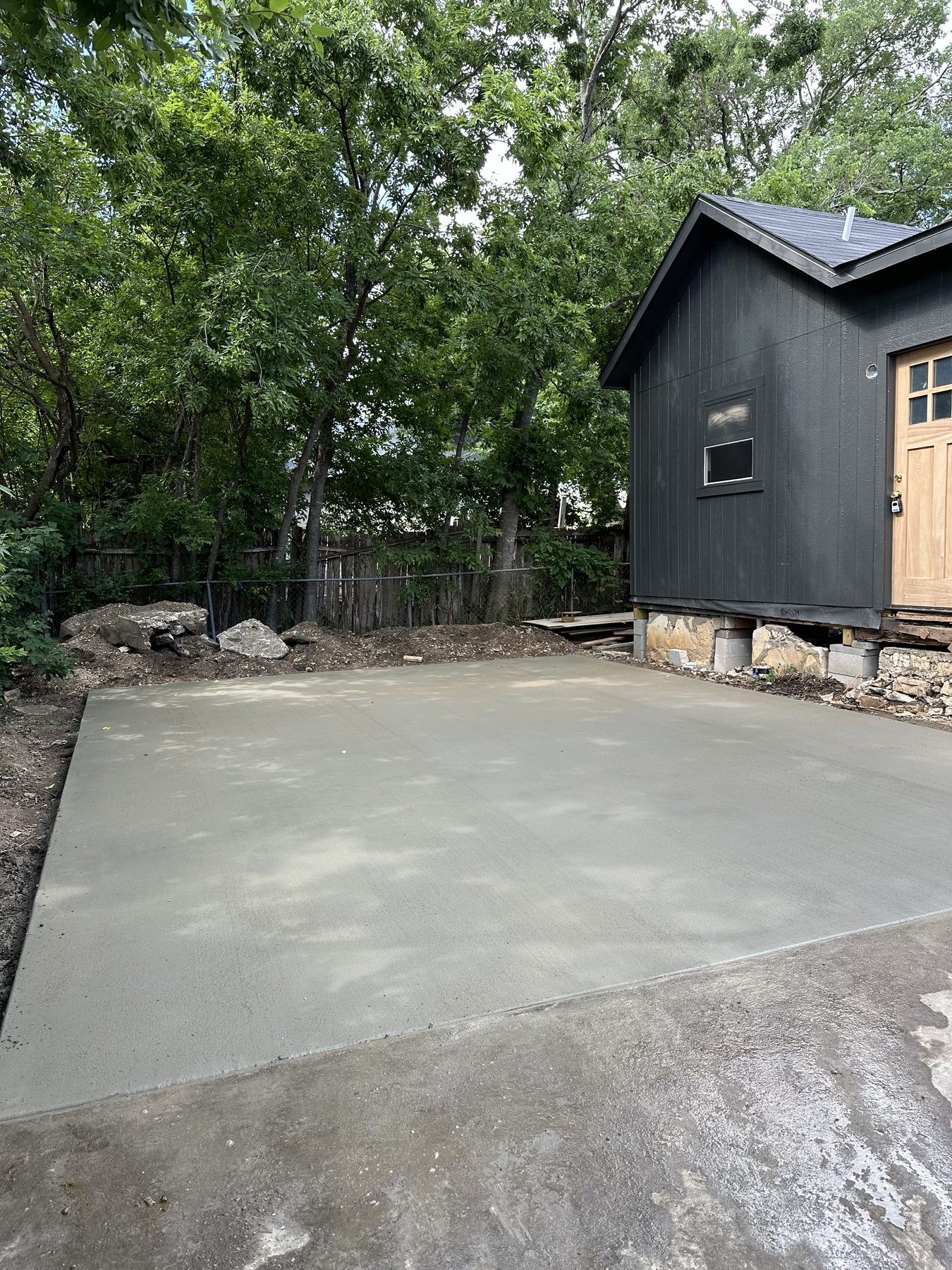 Finished back patio behind a dark-sided house