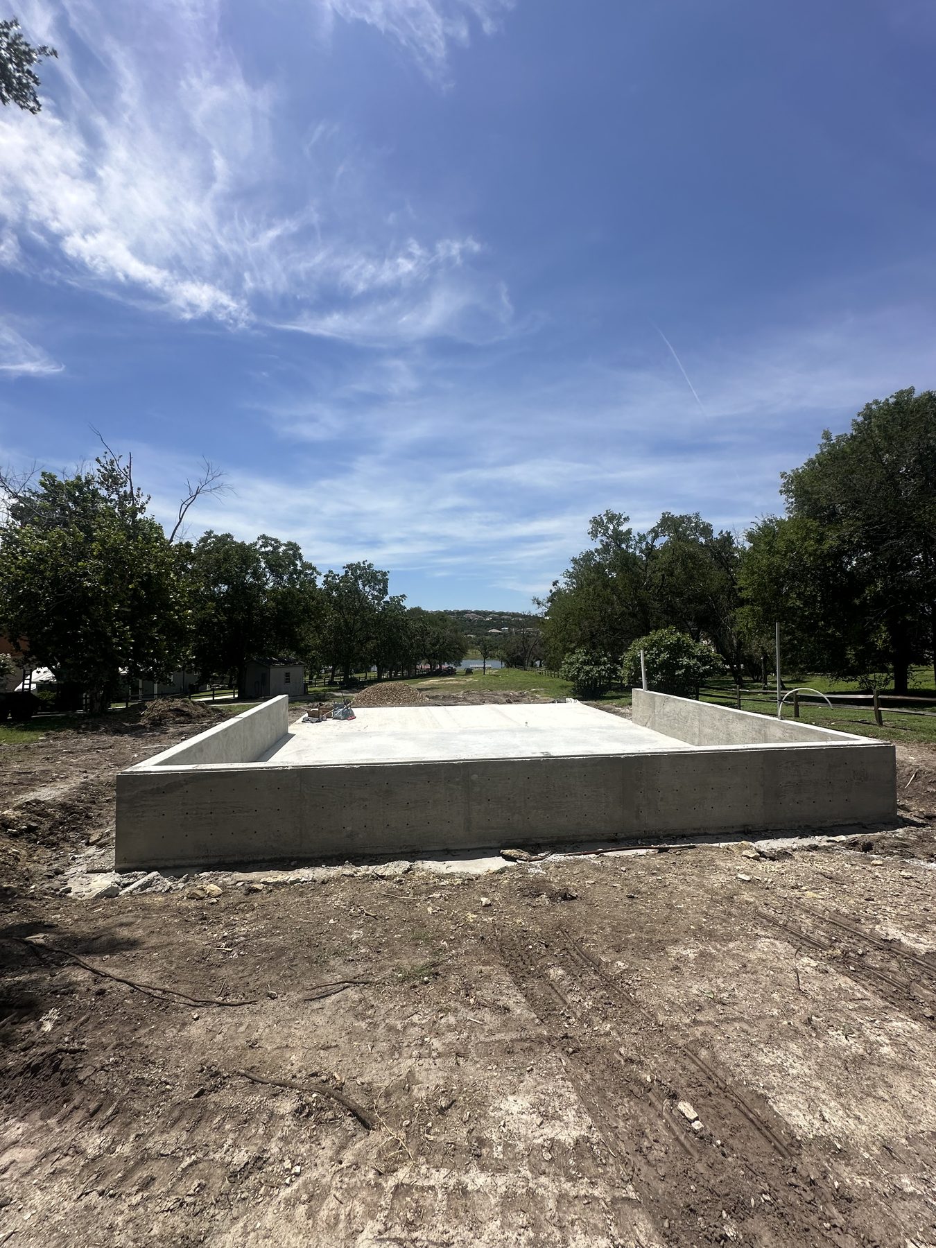 Raised foundation walls beside the lake