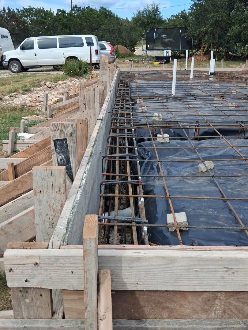 Rebar and forms set around the plumbing rough-in