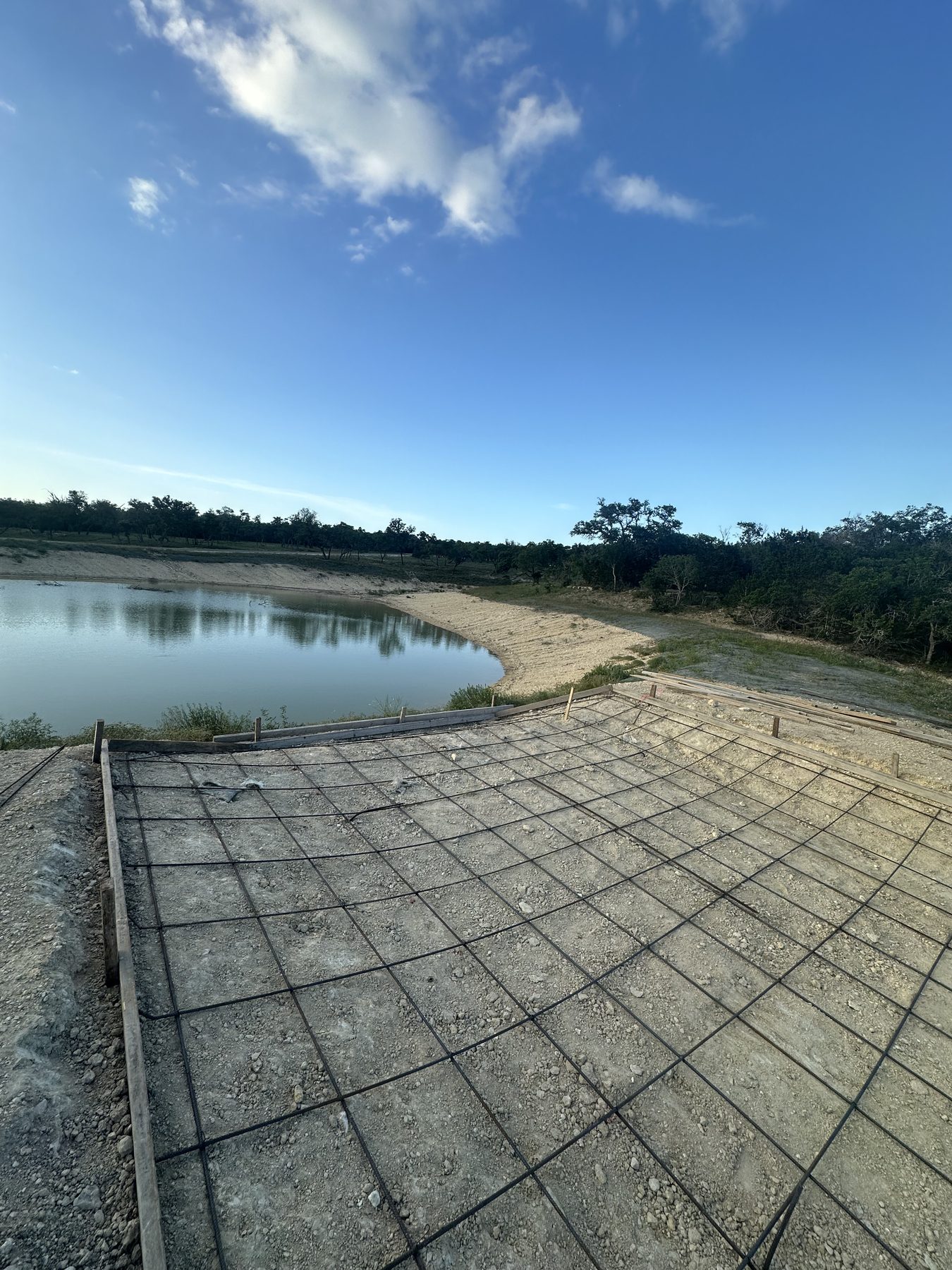 Rebar laid for a slab beside a pond