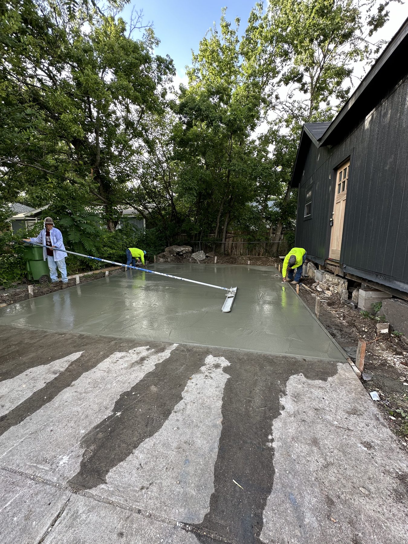 Crew screeding a wet patio slab