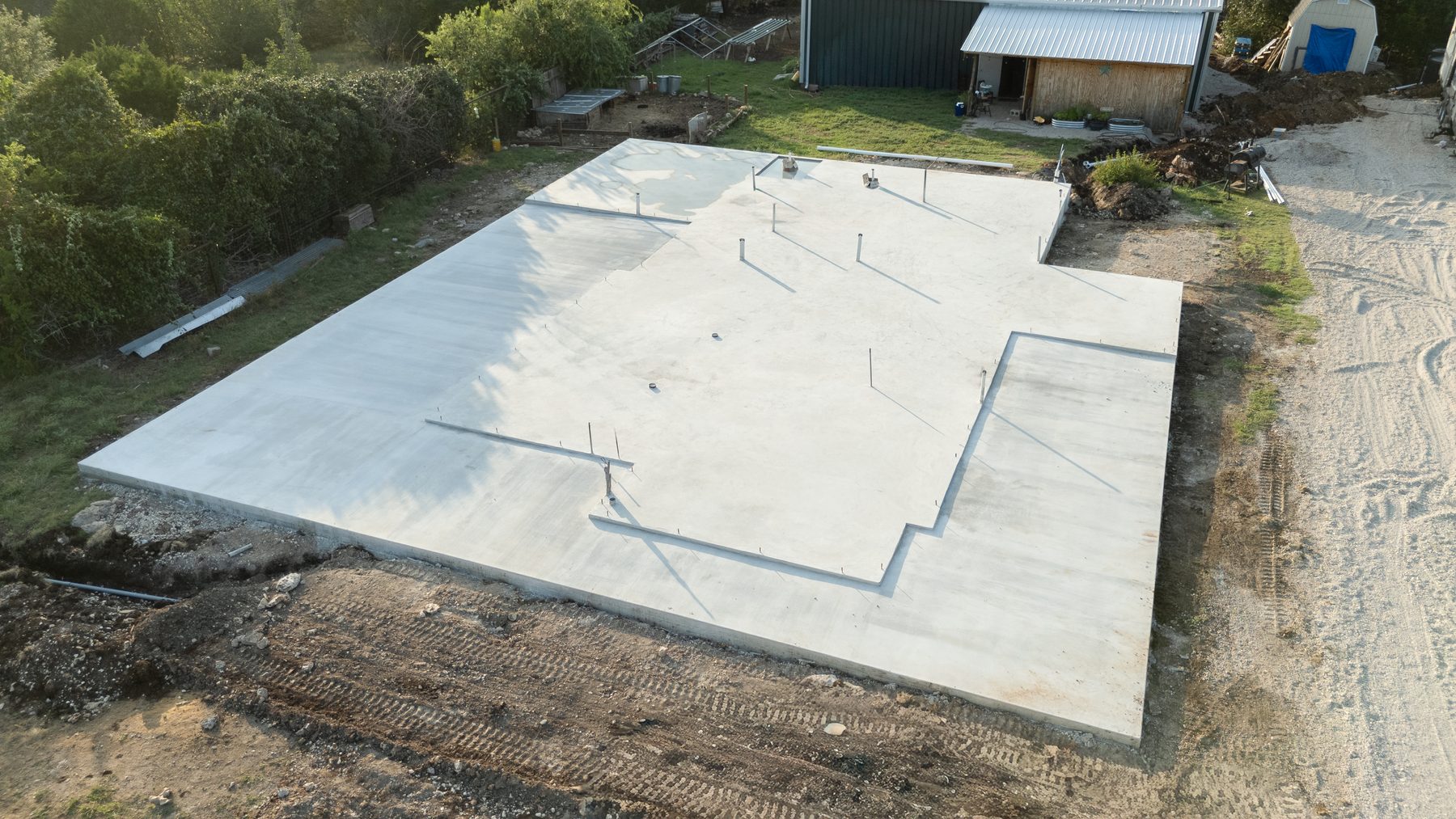 Aerial view of a finished slab foundation with the shop behind it