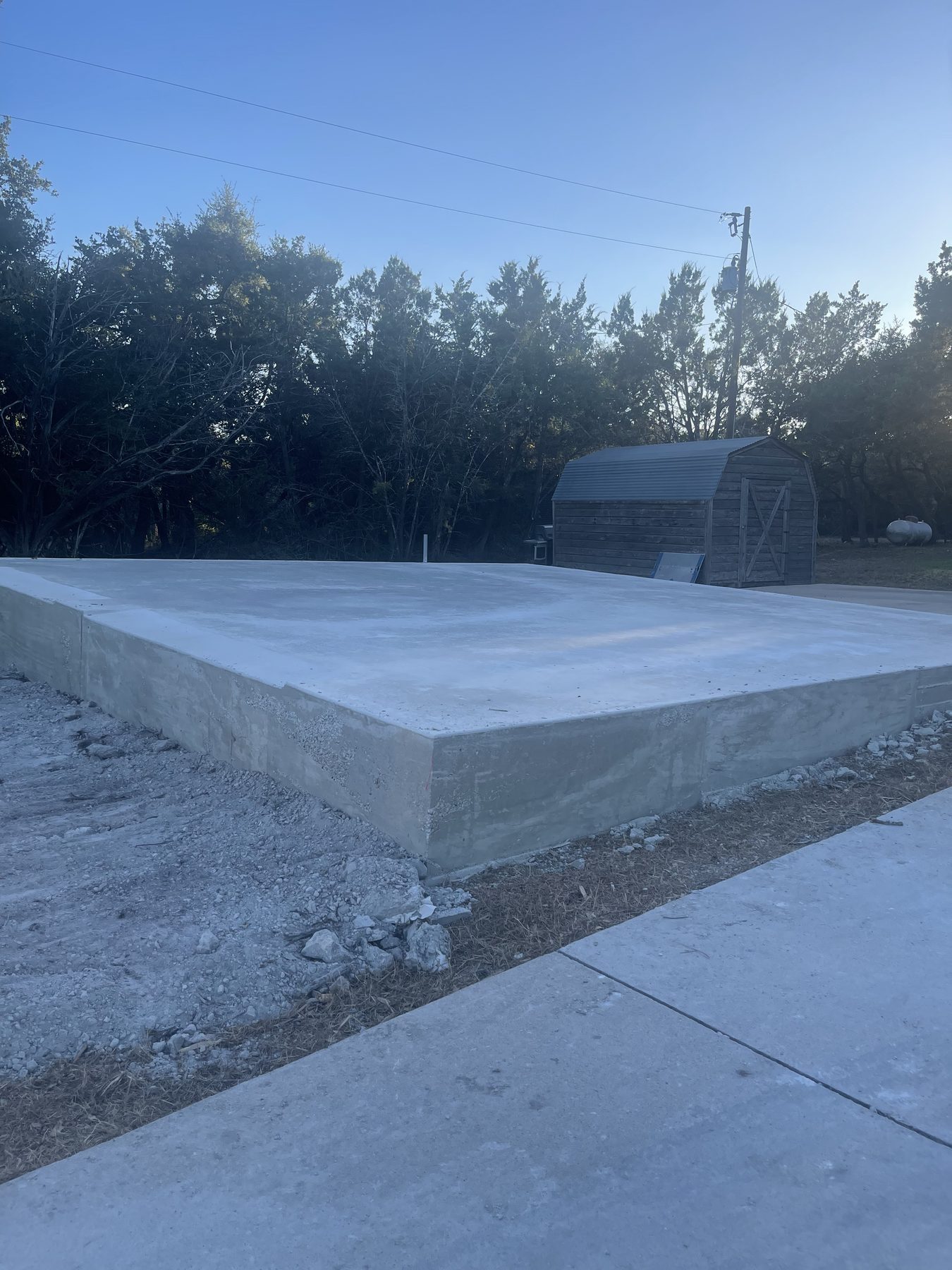 Slab poured beside a shed