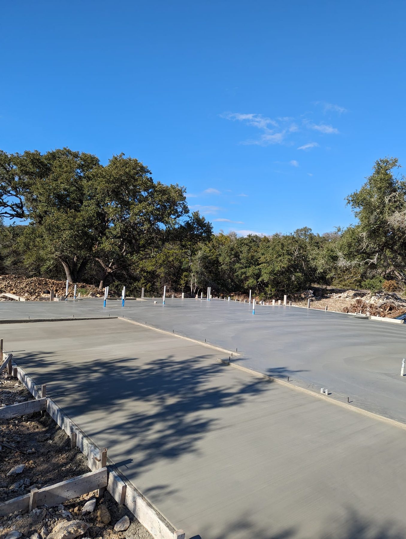 Wide slab foundation poured under live oaks