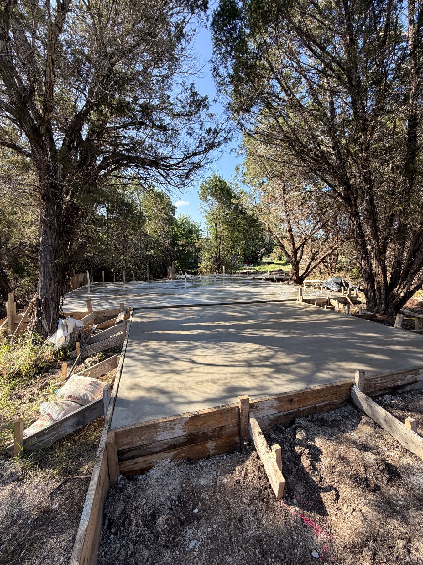 Freshly poured slab curing under the trees