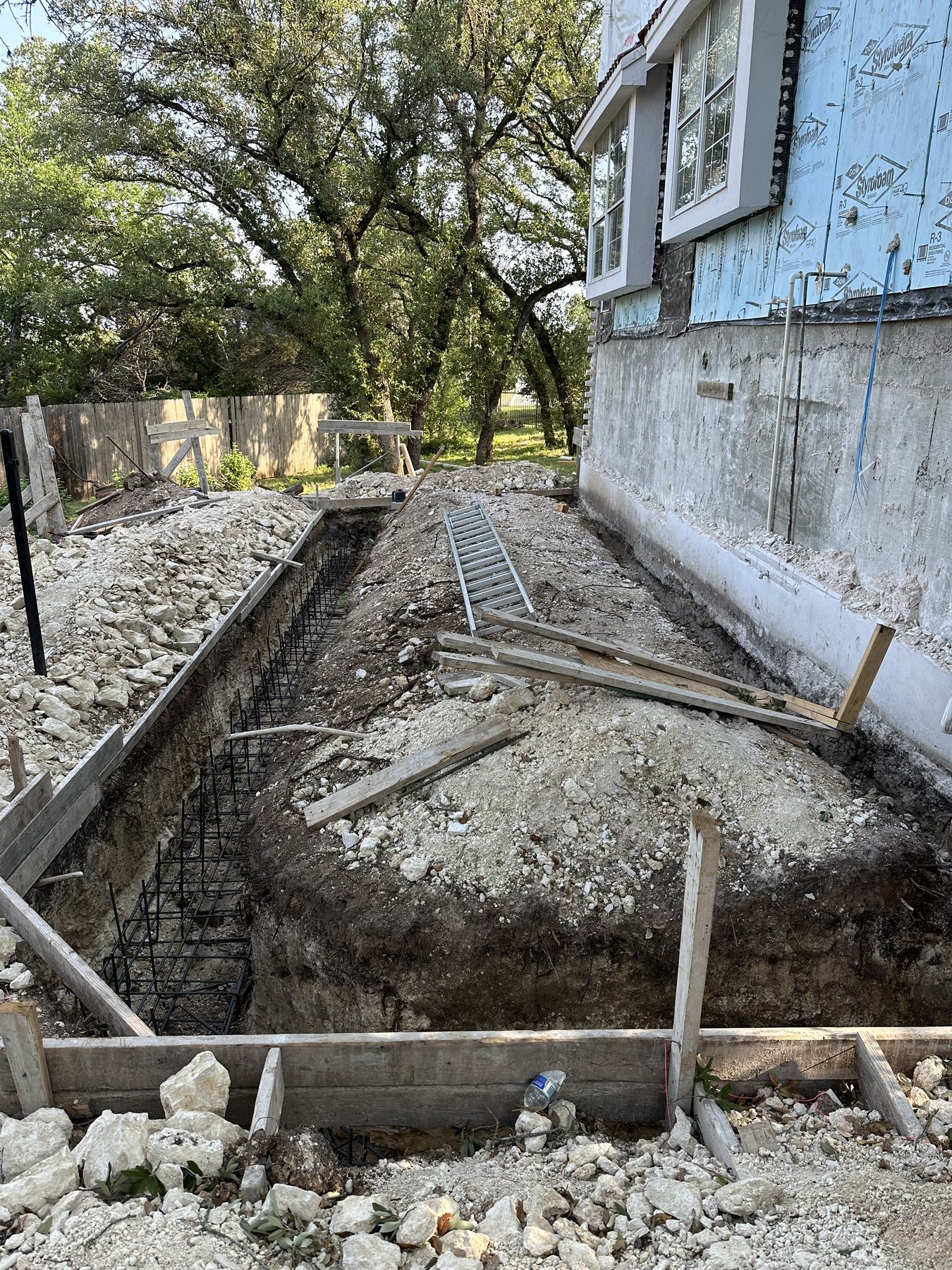 Stem wall footing dug and formed beside the house